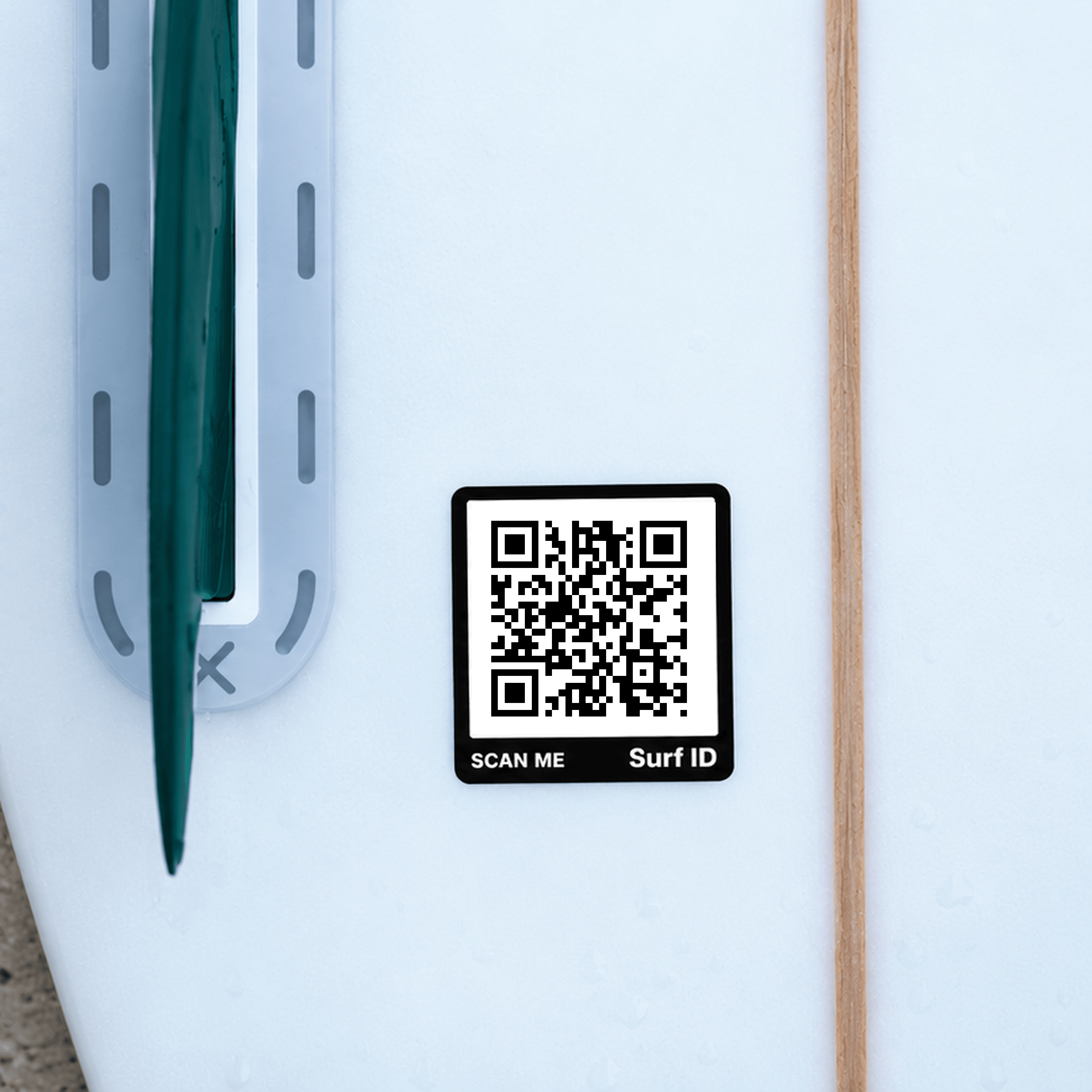 A Surf ID sticker on a white surfboard, next to a fin.